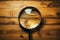 Magnifying glass on wood, uncovering hidden details in plain sight