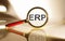 Magnifying glass with word ERP Enterprise Resource Planning