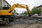 Magnitogorsk, Russia, - May, 17, 2019. Workers and a yellow excavator poured rubble repaired tram rails. Crossroads of Marx and