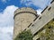 Magnolia branches on the background of an old stone tower. The tower of the Western entrance of Vorontsov Alupka Palace