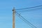 Magpies sitting on a pole with wires