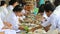 MAHASARAKHAM THAILAND - JULY8,2017: senior woman wearing white clothes eating tradition food in temple on asalha puja day of thai