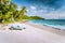 Mahe, Seychelles. Sun lounger at beautiful Anse intendance, tropical beach. Blue ocean waves, sandy beach and coconut