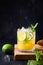Mai Tai cocktail. Rum with tropical fruits and lime garnish mint on black. Vertical format