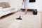 Maid cleaning carpet with vacuum cleaner