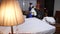 Maid packing used bedding after guest's departure