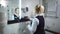 Maid in uniform puts shower gel for visitors. Beautiful interior of bathroom in modern hotel