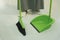 Maid using broom and dustpan on the floor at home