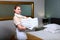 A maid in white cotton gloves holds a stack of towels. Friendly hotel staff. The concept of the hotel business. Photos in the