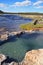 Maidens Grave Hot Spring flowing into the Firehole River in Yellowstone National Park in Wyoming USA