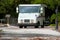 Mail delivery truck with mailboxes in background