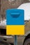 A mailbox in the color of the yellow-blue flag of Ukraine stands in the center of the city of Dnipro in Ukraine, the