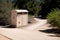 A mailbox at the end of a long dusty driveway