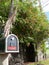 Mailbox with red stripe and red flowers in the back