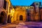 Main access door to medieval church with tower and arched windows. Santillana