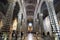 Main aisle and altar from the interior of the Siena Dome Duomo with few visitors during the day