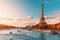 main attraction of Paris and all of Europe is the Eiffel tower in the rays of the setting sun on the bank of Seine river with