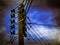 Main electric pole against blue sky with clouds