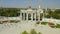 Main entrance arch of exhibitin center VDNKh and pavilions made in Soviet Union architecture style among park with green trees