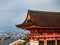 Main Gate of Kiyomizu-dera Temple with brown roof and red wooden base in Kyoto