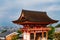 Main Gate of Kiyomizu-dera Temple with brown roof and red wooden base in Kyoto