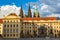 Main gate to the royal area of historical Prague Castle at sunny day, in the background the St Vitus cathedral, Czech Republic