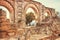 Main gates of 10th century ruined Moorish medieval city Medina Azahara and some tourists walking in Andalucia, Spain