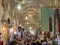 Main hall of the Shiraz Vakil bazar crowded during rush hour, in a covered alley of the market.