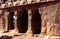 Main hall textured pillars sculpures and wall in mahabalipuram- five rathas
