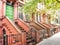 Main ladder and entry door. New york Harlem buildings. Brown houses. NYC, USA