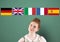 main language flags over young woman thinking. Green background