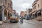 Main muddy street of Tighedouine after rain with regular human and car traffic