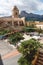 Main square with flags at the church of Polop de Marina with mountainrange, Costa Blanca, Spain