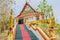 The main stair leading to the replica of Phra That In-Kwaen (Hanging Golden Rock) at Sirey temple, Phuket, Thailand.