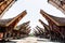 Main street of traditional Tana Toraja village with buffalo in the foreground , tongkonan houses. Patawa, Sulawesi, Indonesia