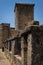 The main tower of Miranda Castle stands behind the stone wall in a day with blue sky, Miranda del CastaÃ±ar, Salamanca, Spain