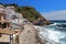 Main view of cala Margarida, a lovely beach surrounded by traditional fishermen`s white buildings with colorful doors and windows.