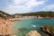 Main view of crowdy beach of Tamariu with village in background, Costa Brava, Catalonia, Spain