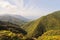 Main view of the northern massive green mountains and seaside of Yakushima Island with city of Miyanoura on background