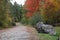 Maine country road in autumn with boulders