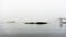 Maine lobster boat at anchor in early morning fog