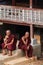 Maing Thauk, Myanmar - April 2019: Buddhist monks sit on a monastery porch at Inle lake