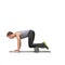 Maintaining balance. A young man doing push-ups on his exercise mat with his legs raised by a foam roller.