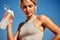 Maintaining hydration. A woman drinks water during a workout, replenishing her water-salt balance, beautiful light, a
