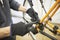 Maintenance of a bicycle: person disassembling an orange bike in his repair shop