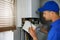 Maintenance and repair service engineer working with house gas heating boiler