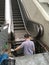 Maintenance technician does escalator service