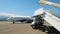 Maintenance worker checking airplane wheels before passenger boarding, airport