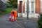 A maintenance worker in high visibility clothing laying out cones in a street