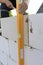 Maintenance worker holding aluminium spirit level tool or bubble levels at construction site. Equipment for civil engineering